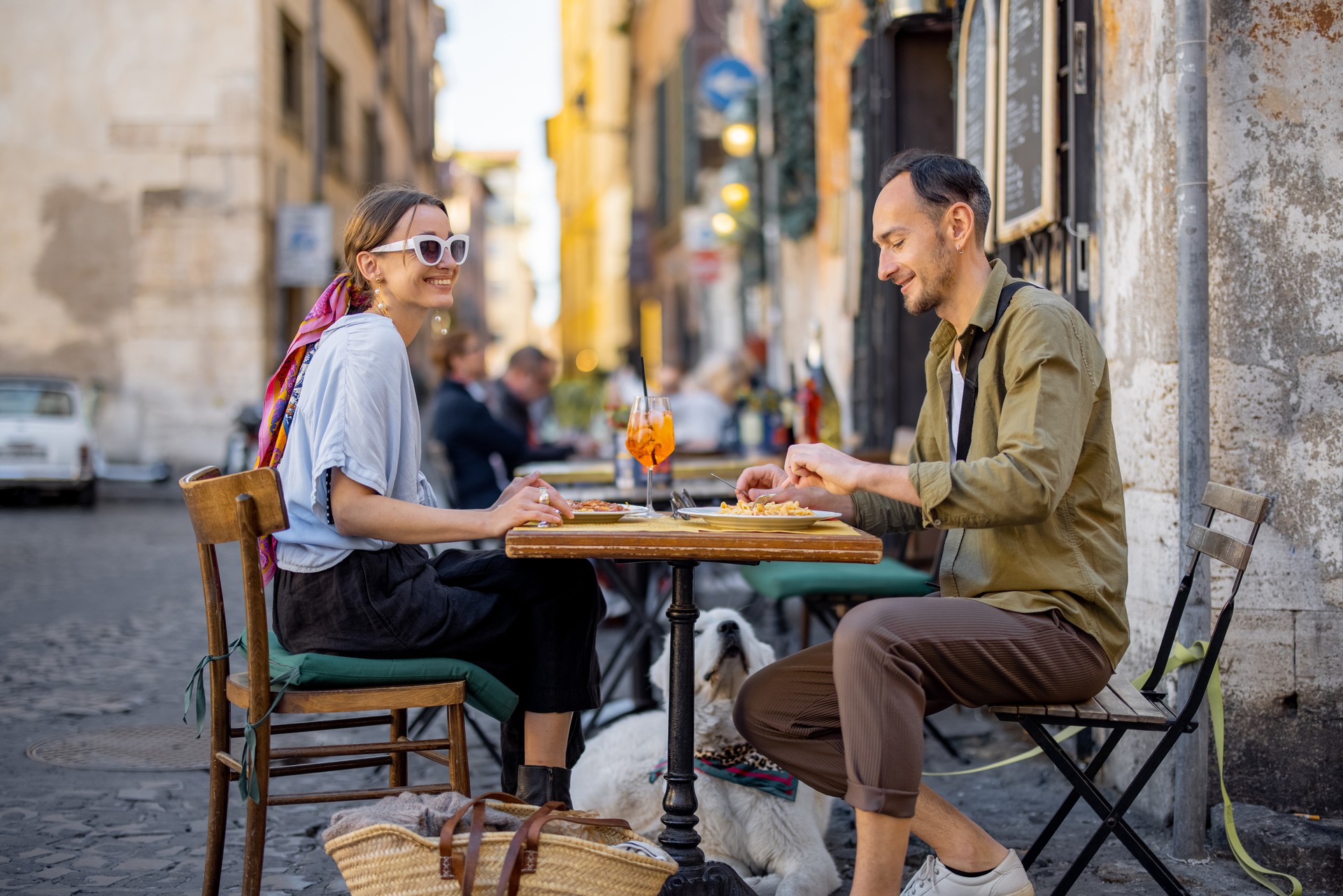 Woman eating italian pasta at restaurant on the street in Rome